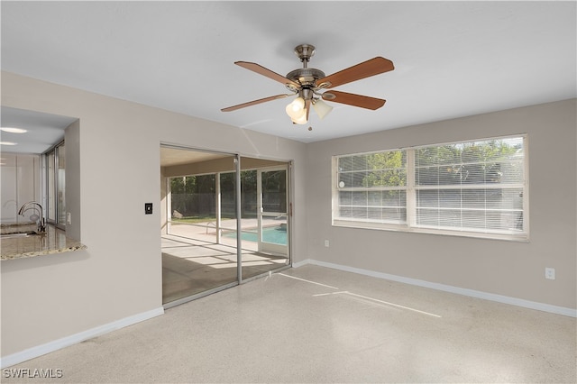 spare room with ceiling fan and sink