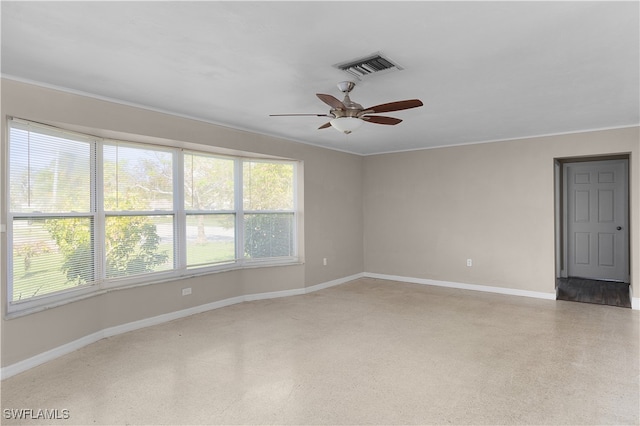 empty room featuring ornamental molding and ceiling fan