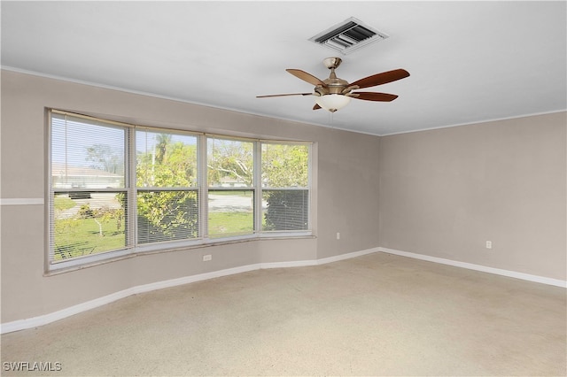 carpeted spare room featuring ornamental molding and ceiling fan