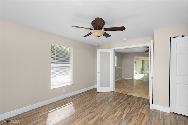 unfurnished room with hardwood / wood-style floors, ceiling fan, and french doors