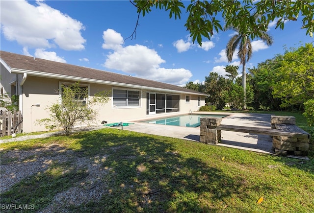 view of swimming pool with a patio and a yard