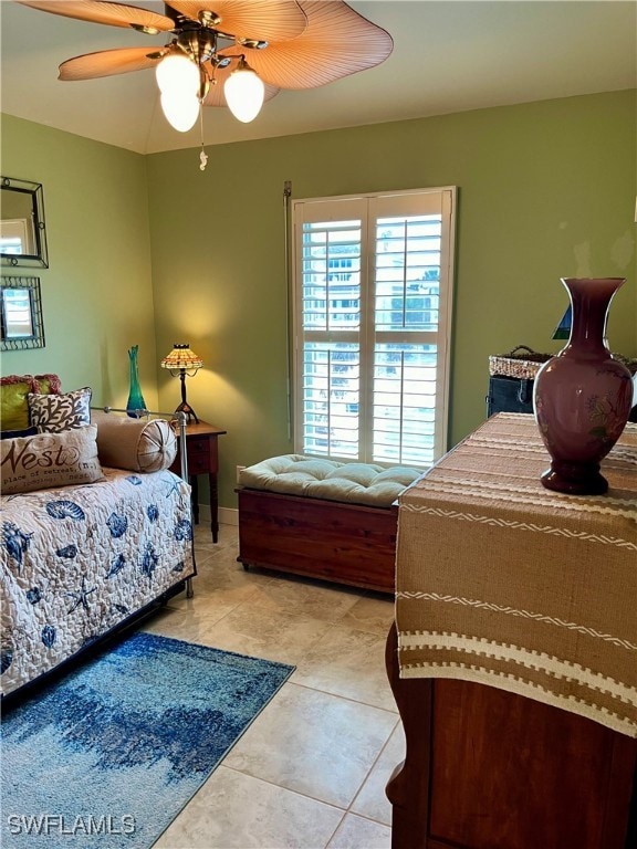 bedroom featuring light tile patterned floors and ceiling fan