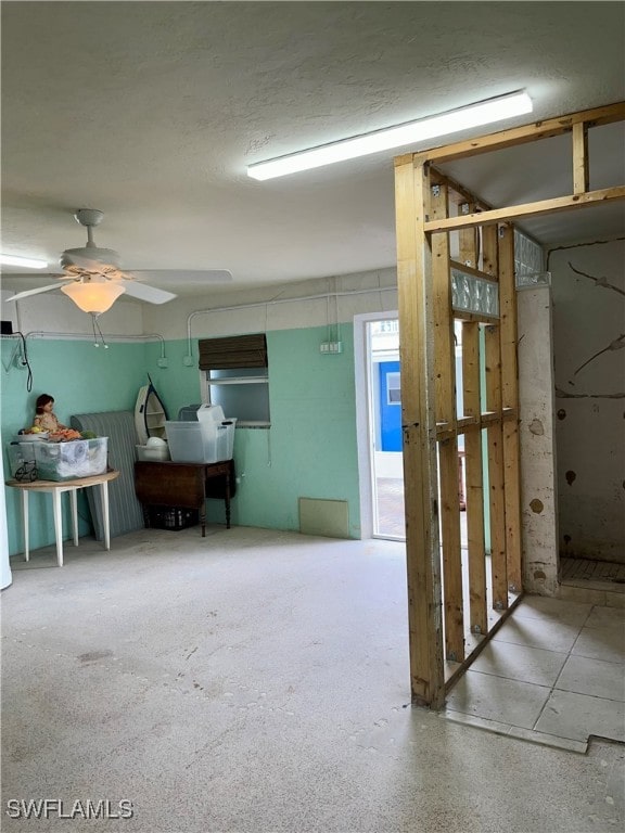 interior space with ceiling fan