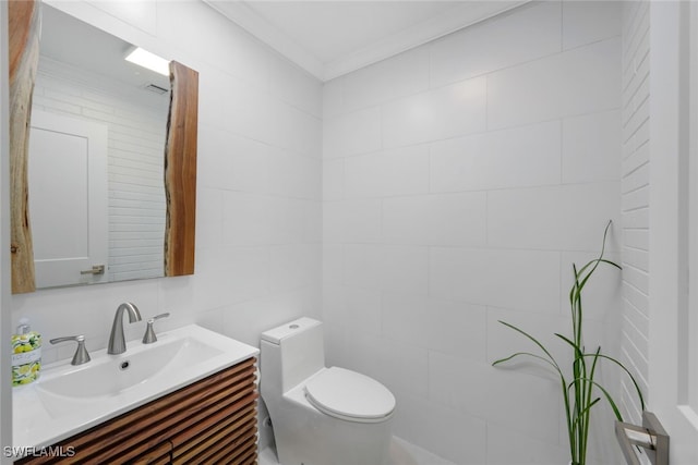 bathroom with vanity, toilet, and crown molding