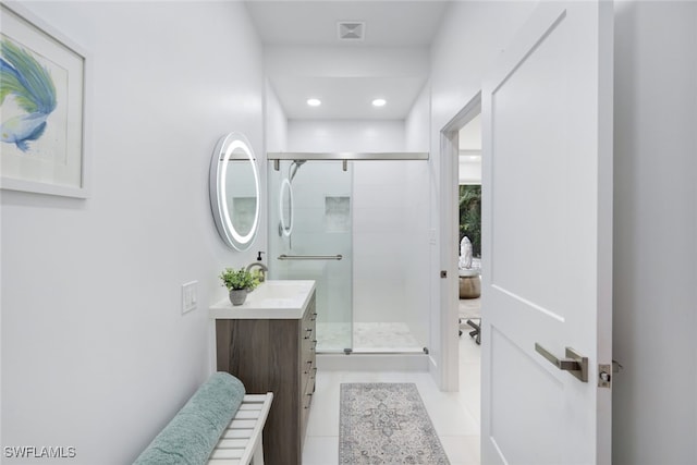 bathroom with tile patterned flooring, vanity, and an enclosed shower