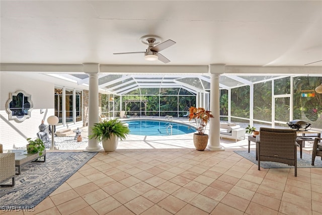 view of pool with a patio, ceiling fan, and a lanai