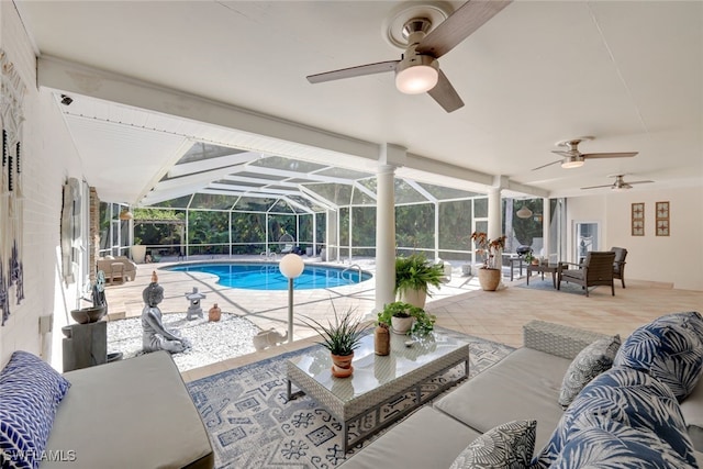 view of pool with outdoor lounge area, a lanai, and a patio