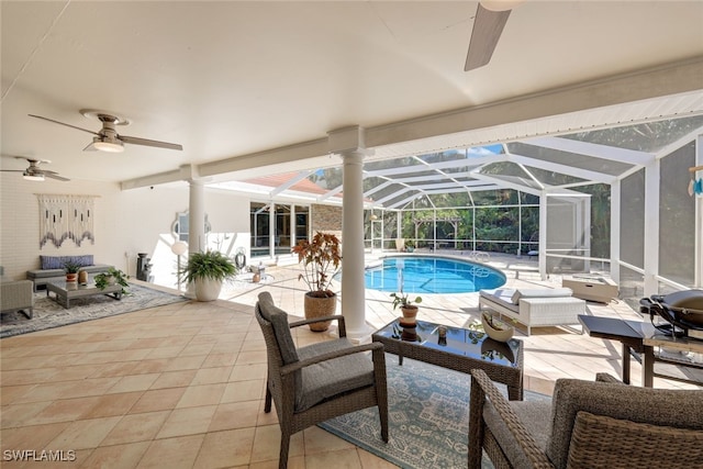 view of swimming pool featuring an outdoor living space, a patio, ceiling fan, and a lanai