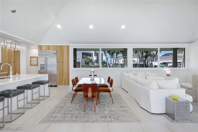 dining space featuring a healthy amount of sunlight, wood ceiling, sink, and vaulted ceiling