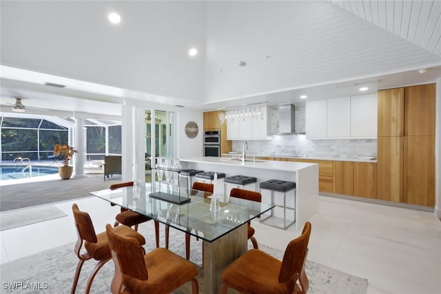 dining room with ceiling fan, sink, high vaulted ceiling, light tile patterned floors, and wood ceiling