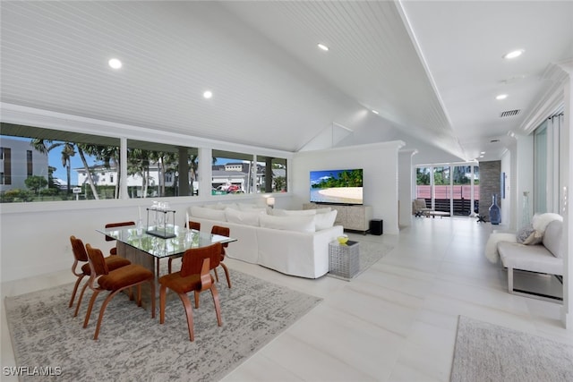 living room with a wealth of natural light and vaulted ceiling