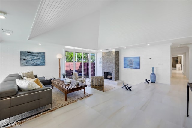 living room featuring a fireplace and a high ceiling