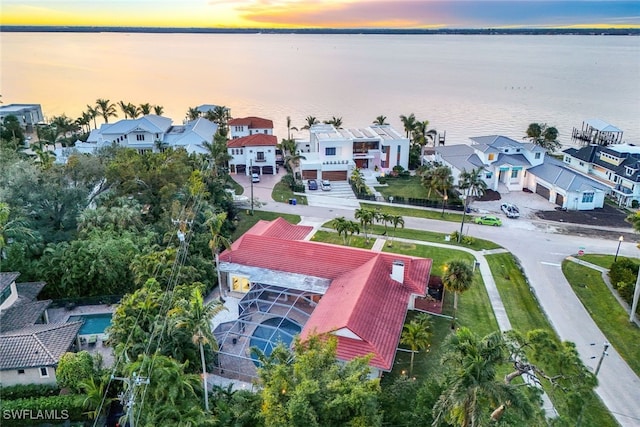 aerial view at dusk with a water view