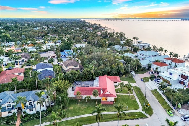 aerial view at dusk with a water view