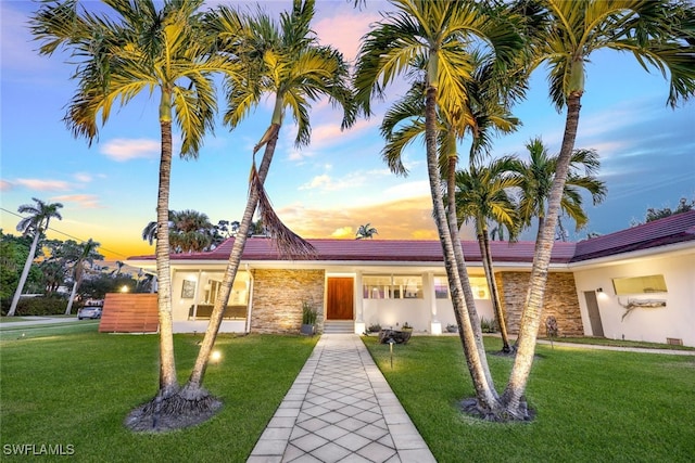 view of front of property with a lawn