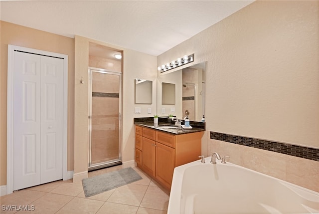 bathroom with vanity, plus walk in shower, a textured ceiling, and tile patterned floors