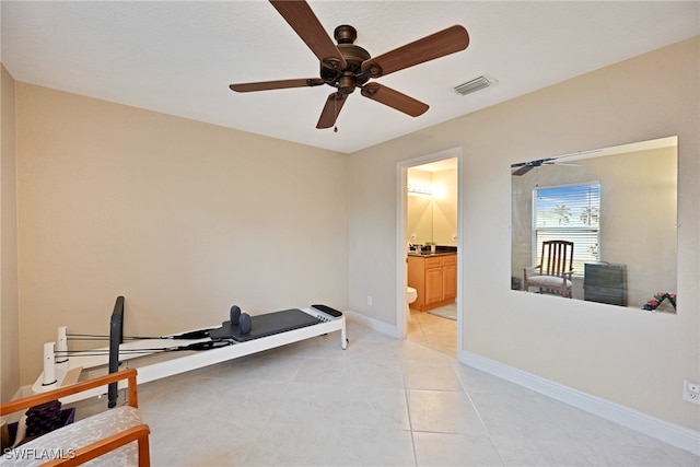 workout area with light tile patterned floors and ceiling fan