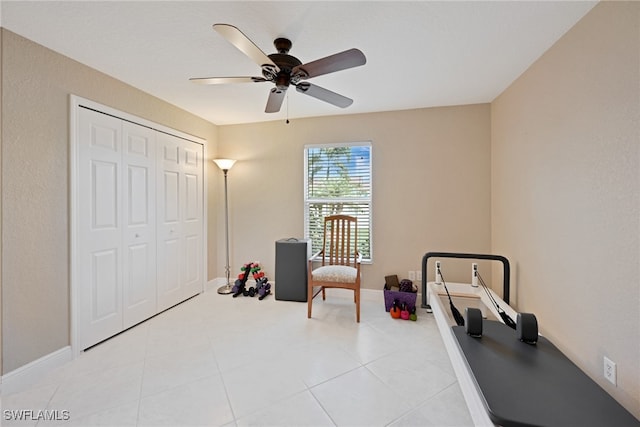 interior space with light tile patterned floors and ceiling fan