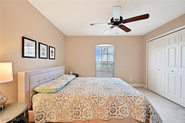 carpeted bedroom with a closet and ceiling fan