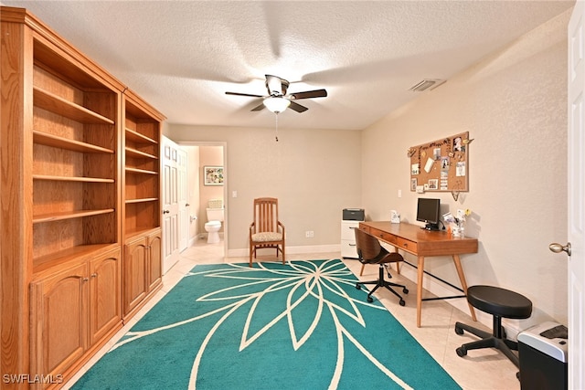 office space featuring ceiling fan and a textured ceiling