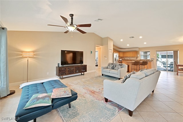 tiled living room featuring ceiling fan and vaulted ceiling