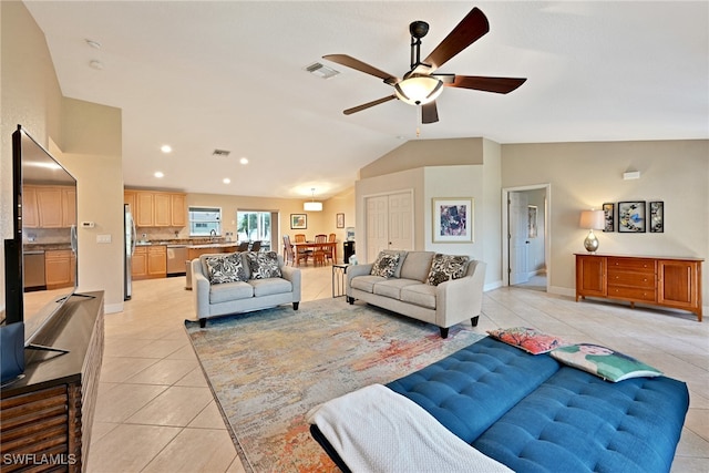 living room featuring vaulted ceiling, light tile patterned floors, and ceiling fan