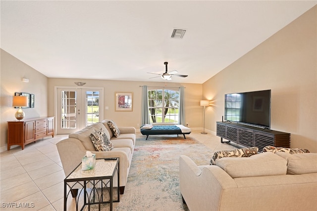 living room with ceiling fan, light tile patterned floors, and vaulted ceiling