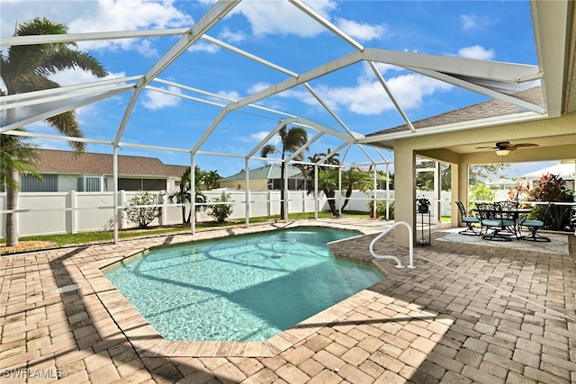 view of pool featuring ceiling fan, a lanai, and a patio