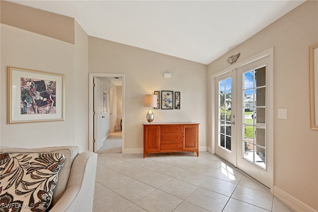 doorway to outside featuring vaulted ceiling, light tile patterned floors, and french doors