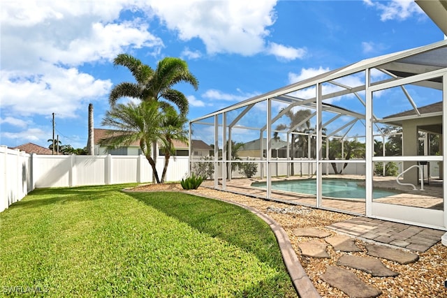 exterior space with a lanai, a yard, and a patio area