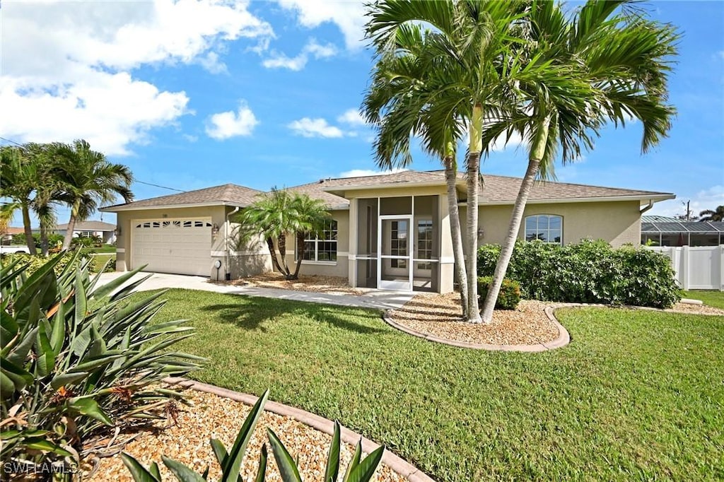 3305 SW 26th Pl, Cape Coral, FL 33914 - ranch-style house featuring stucco siding, an attached garage, driveway, and a sunroom