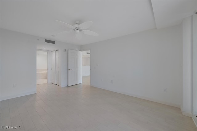 empty room featuring light hardwood / wood-style flooring and ceiling fan