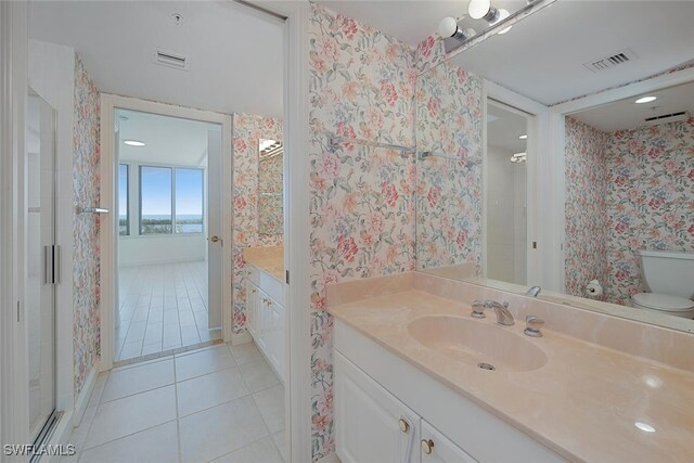 6849 Grenadier Blvd Unit 603, Naples, FL 34108 - full bathroom with vanity, tile patterned floors, toilet, and wallpapered walls