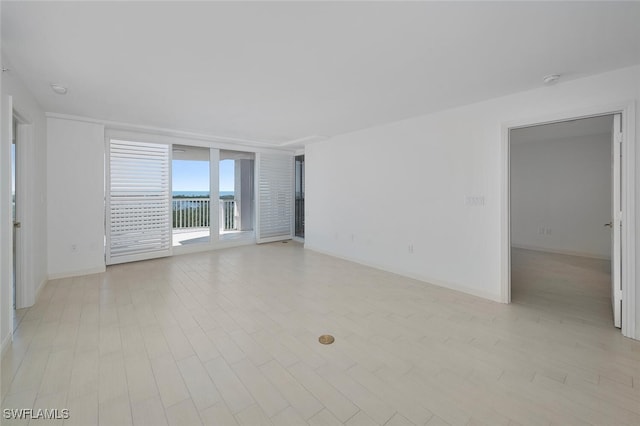6849 Grenadier Blvd Unit 603, Naples, FL 34108 - empty room featuring baseboards and light wood-type flooring