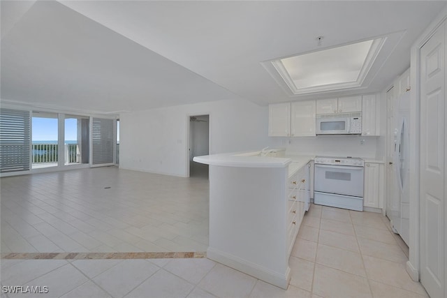 kitchen featuring white cabinetry, light tile patterned flooring, white appliances, and kitchen peninsula