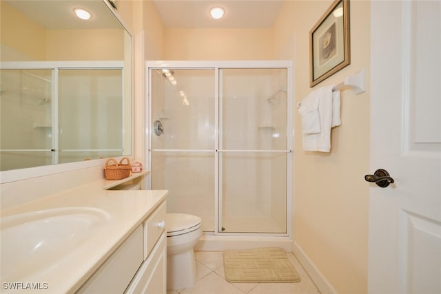 bathroom featuring toilet, vanity, tile patterned floors, and a shower with shower door