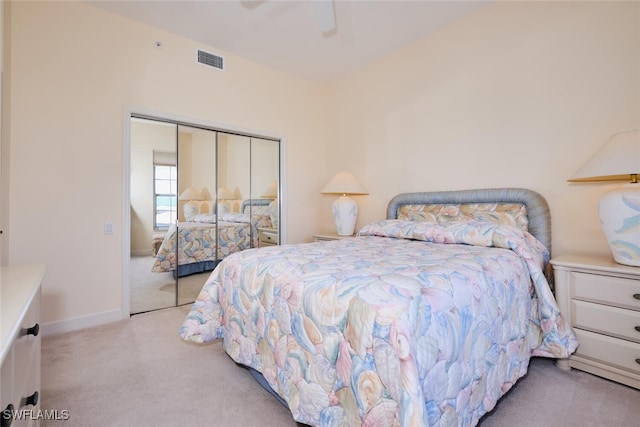 carpeted bedroom featuring ceiling fan and a closet