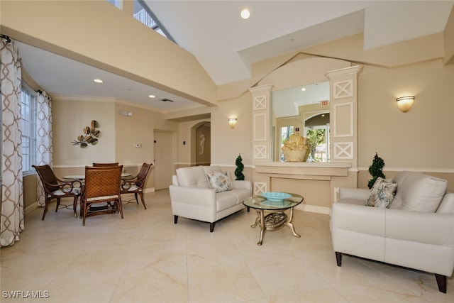 living room featuring a wealth of natural light, ornamental molding, and decorative columns