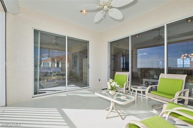 sunroom / solarium featuring ceiling fan