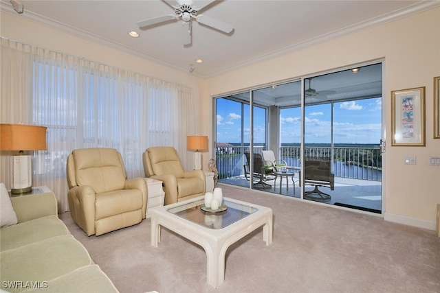 carpeted living room featuring ceiling fan, a water view, and ornamental molding