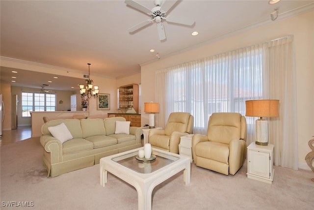 carpeted living room featuring ceiling fan with notable chandelier and crown molding