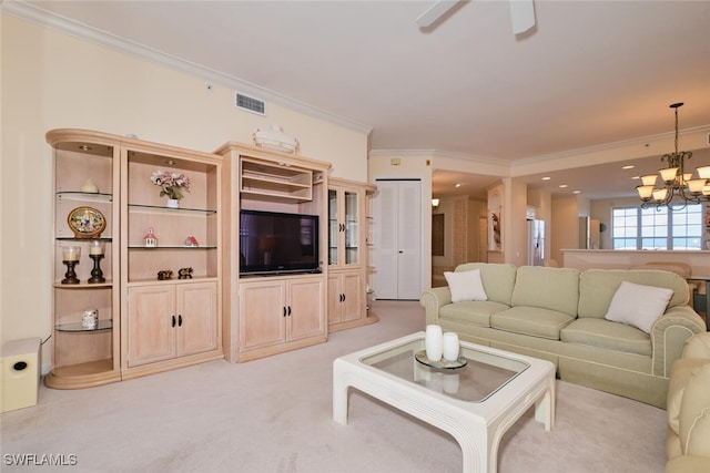 living room with light carpet, ornamental molding, and ceiling fan with notable chandelier