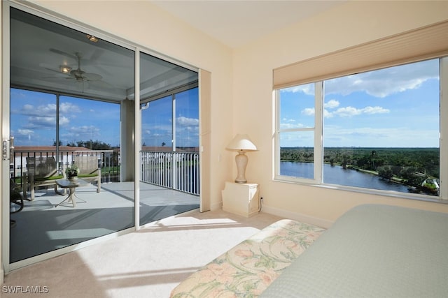 carpeted bedroom with a water view