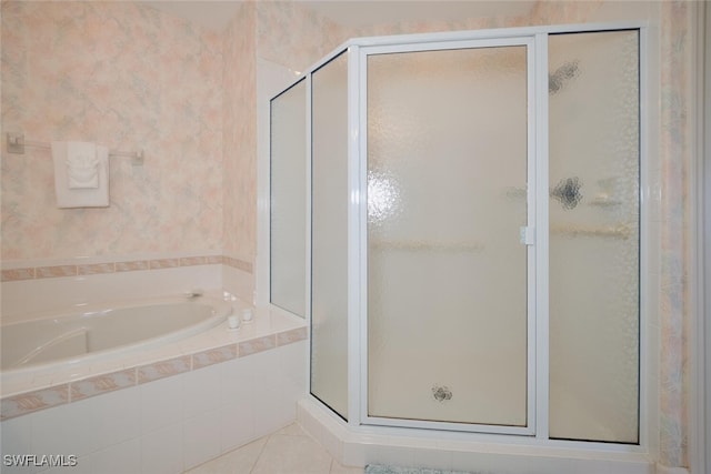 bathroom featuring tile patterned flooring and shower with separate bathtub