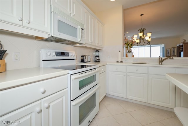 kitchen featuring tasteful backsplash, light tile patterned flooring, white cabinetry, white appliances, and a chandelier