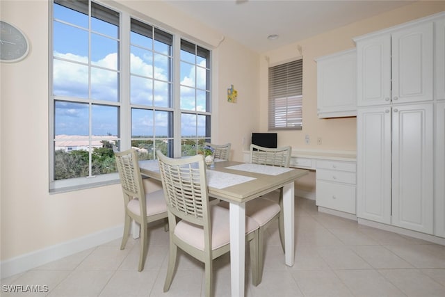 tiled dining space with plenty of natural light and built in desk