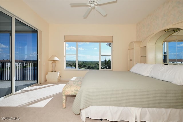 carpeted bedroom with ceiling fan and access to exterior