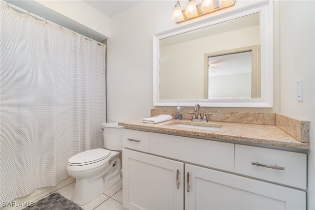 bathroom featuring toilet, vanity, and tile patterned floors