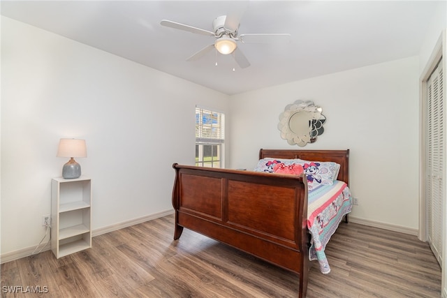 bedroom featuring hardwood / wood-style flooring, ceiling fan, and a closet