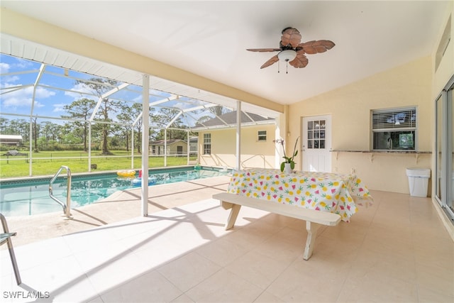 exterior space with ceiling fan, vaulted ceiling, and a pool